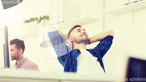 Image of happy creative man with computer at office