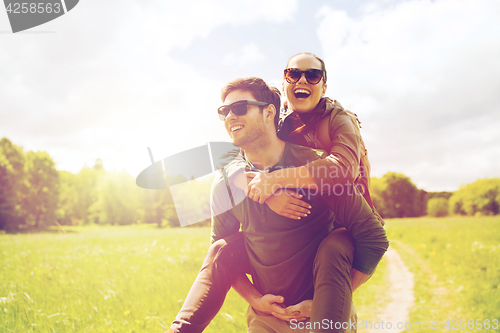 Image of happy couple with backpacks having fun outdoors