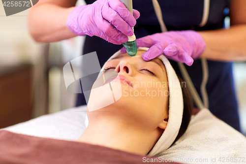 Image of woman having microdermabrasion facial treatment