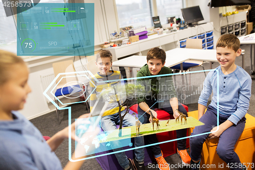 Image of group of happy children with tablet pc at school