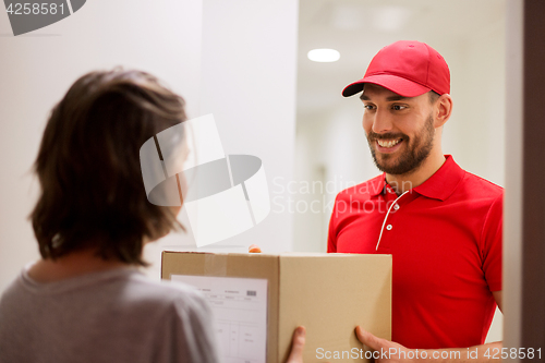 Image of happy delivery man giving parcel box to customer