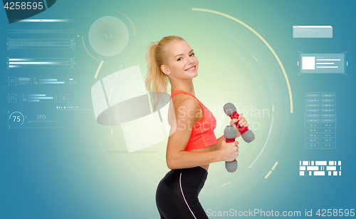 Image of happy young sporty woman exercising with dumbbells