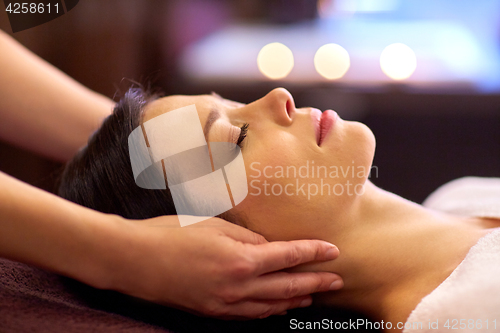 Image of woman having face and head massage at spa