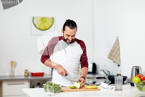 Image of man with blender and fruit cooking at home kitchen