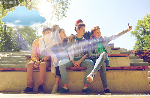 Image of happy teenage students taking selfie by smartphone