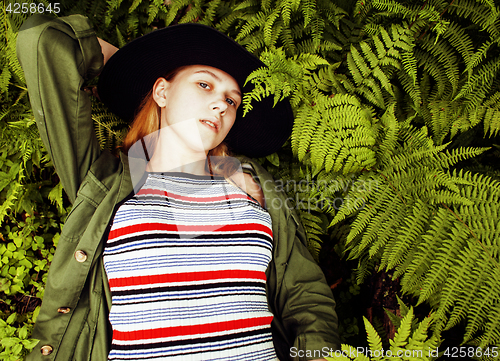 Image of Pretty young blond girl hipster in hat among fern, vacation in green forest, lifestyle fashion people concept