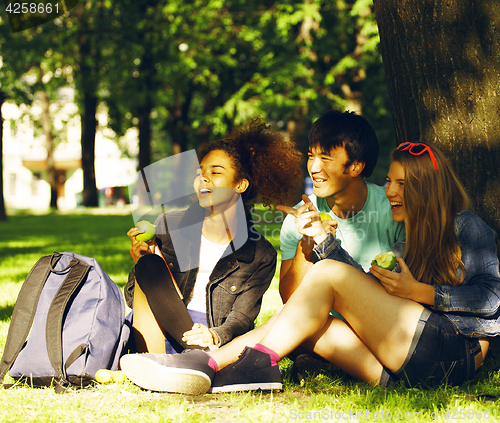 Image of cute group of teenages at the building of university with books 