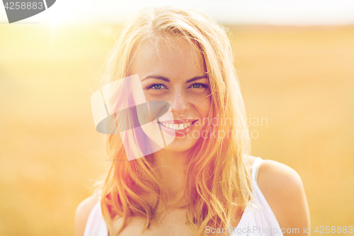 Image of smiling young woman in white on cereal field