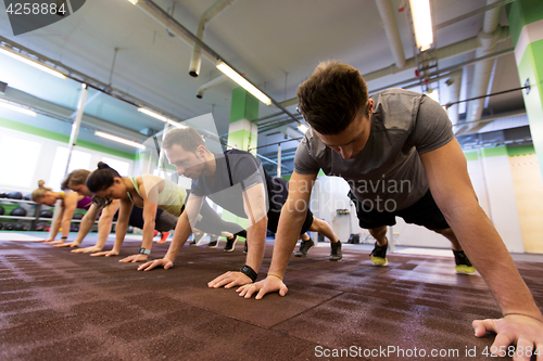 Image of group of people exercising in gym