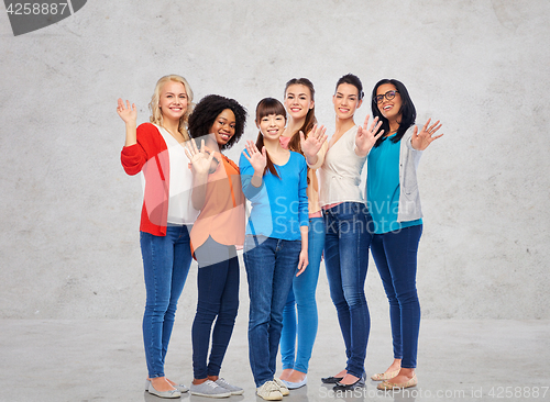 Image of international group of happy women waving hands