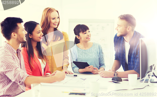 Image of happy creative team or students working at office