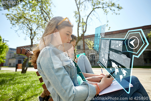 Image of group of students with smartphone and notebooks