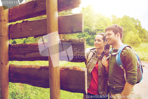 Image of smiling couple with backpacks hiking