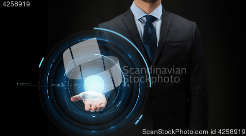 Image of businessman with virtual projection over black