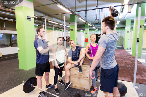 Image of group of friends with sports equipment in gym