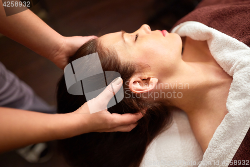 Image of woman having head massage at spa