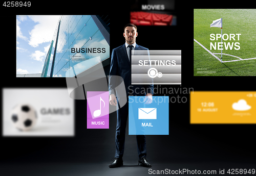 Image of businessman with virtual applications