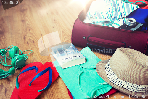 Image of close up of travel bag with clothes and stuff