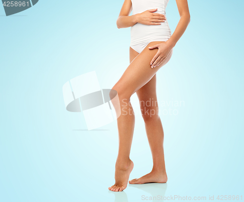 Image of legs of beautiful young woman in white underwear