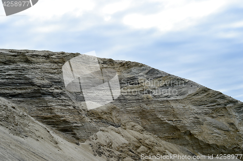 Image of Sandy hill in a quarry against the sky