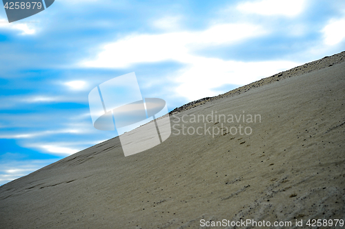 Image of Sandy hill in a quarry against the sky