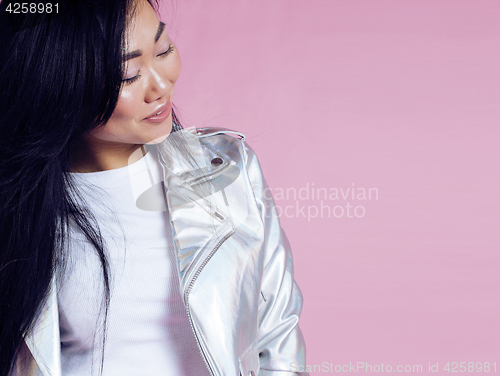 Image of young pretty smiling asian korean girl wearing modern fashion clothers on pink background, lifestyle people concept 