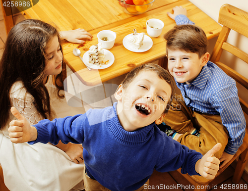 Image of little cute boys eating dessert on wooden kitchen. home interior. smiling adorable friendship together forever friends, lifestyle people concept 