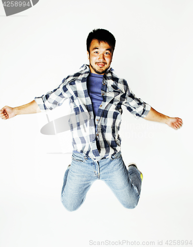 Image of young pretty asian man jumping cheerful against white background