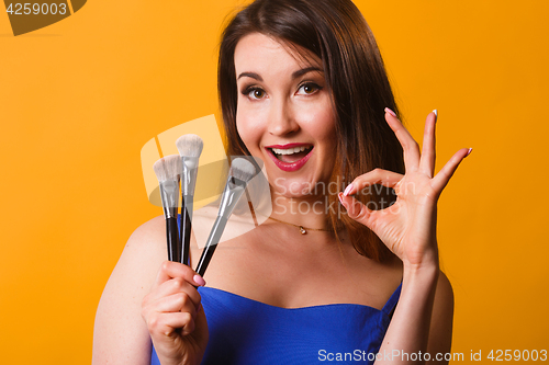 Image of Photo of girl with brushes