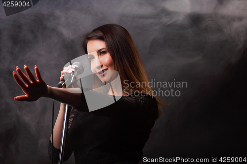 Image of Studio photo of singing woman