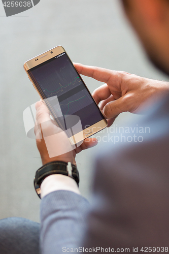 Image of Close up of businessman using mobile smart phone.