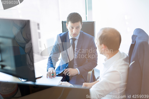 Image of Two businessmen discussing a bisiness problem at meeting in trading office.