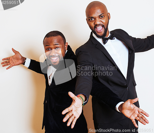 Image of two afro-american businessmen in black suits emotional posing, g