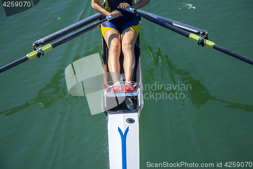 Image of A young girl rowing in boat on water