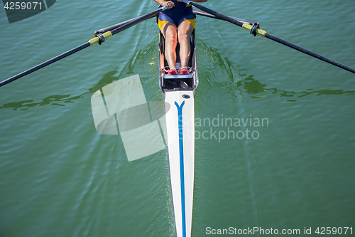 Image of A young girl rowing in boat on water