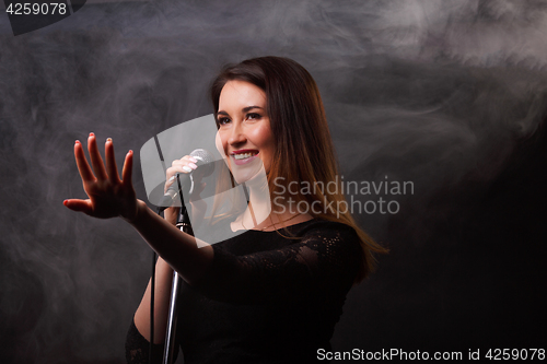 Image of Studio photo of singing brunette