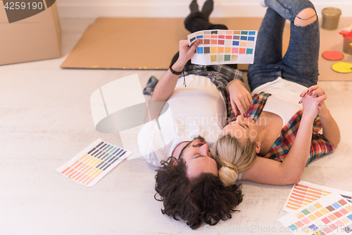 Image of Happy young couple relaxing after painting