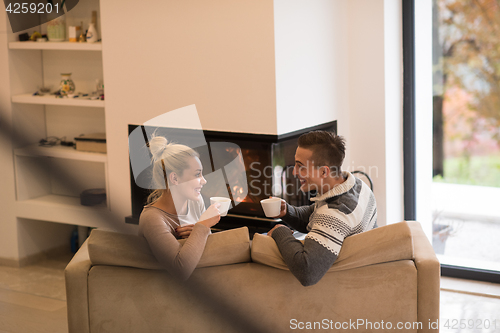 Image of Young couple  in front of fireplace