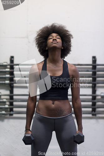 Image of black woman doing bicep curls