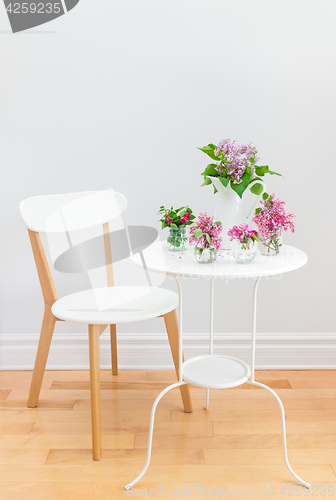Image of Elegant interior with table, chair and spring flowers