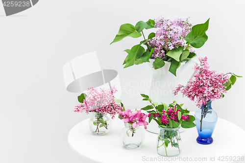 Image of Bouquets of spring flowers on a white table