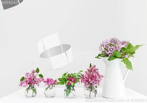 Image of Vases with pink and purple spring flowers