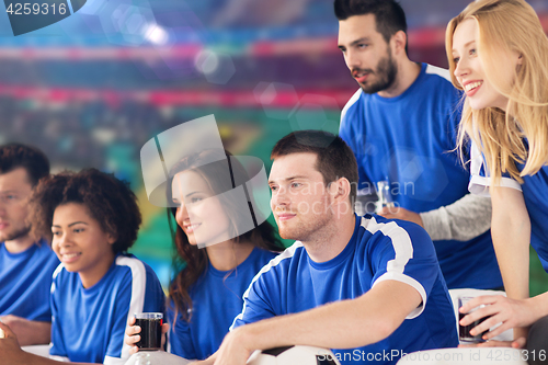 Image of football fans watching soccer match at stadium