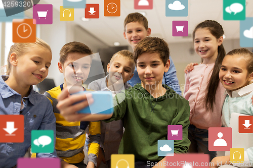 Image of group of school kids taking selfie with smartphone