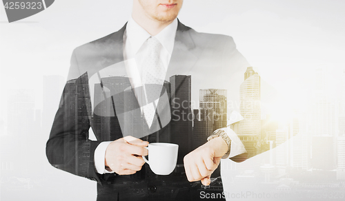 Image of close up of businessman with wristwatch and coffee