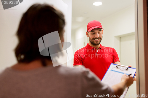 Image of deliveryman with clipboard at customer home