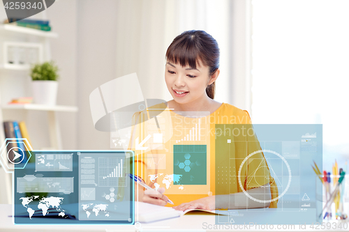 Image of happy asian young woman student learning at home