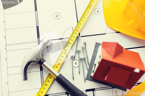 Image of close up of house blueprint with building tools