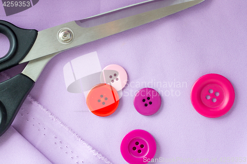 Image of scissors, sewing buttons and cloth