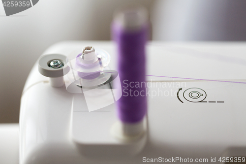 Image of thread spools on sewing machine